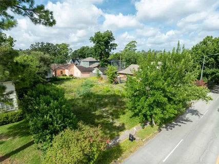 a yellow house with trees in front of it