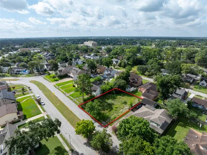 an aerial view of a residential houses with a green yard