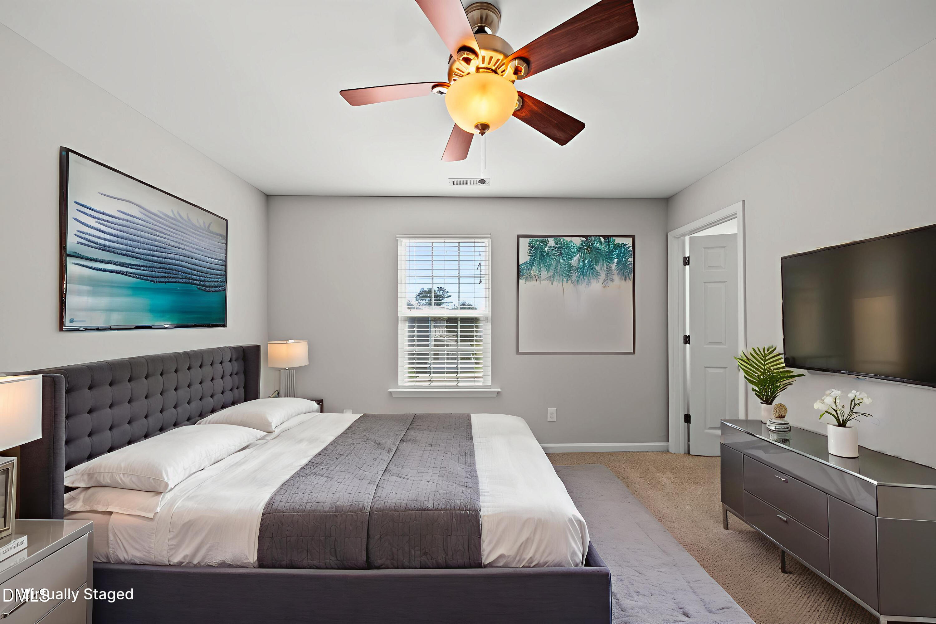 404 Provincial Street Raleigh, NC 27603 - Photo 13 of 24 a bedroom with a large bed and a flat screen tv