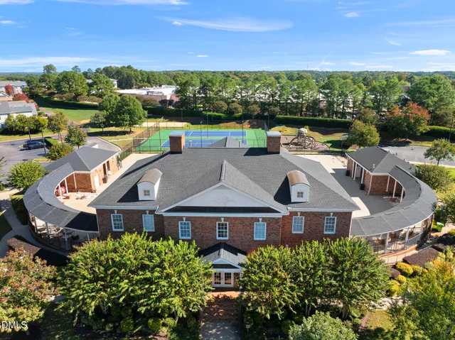 an aerial view of multiple houses with a yard