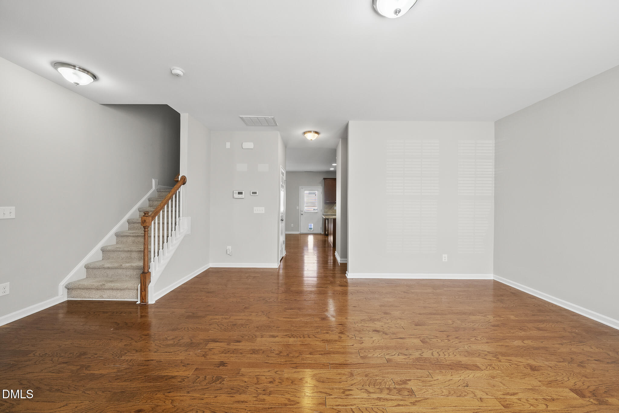 404 Provincial Street Raleigh, NC 27603 - Photo 3 of 24 a view of an empty room with wooden floor and staircase