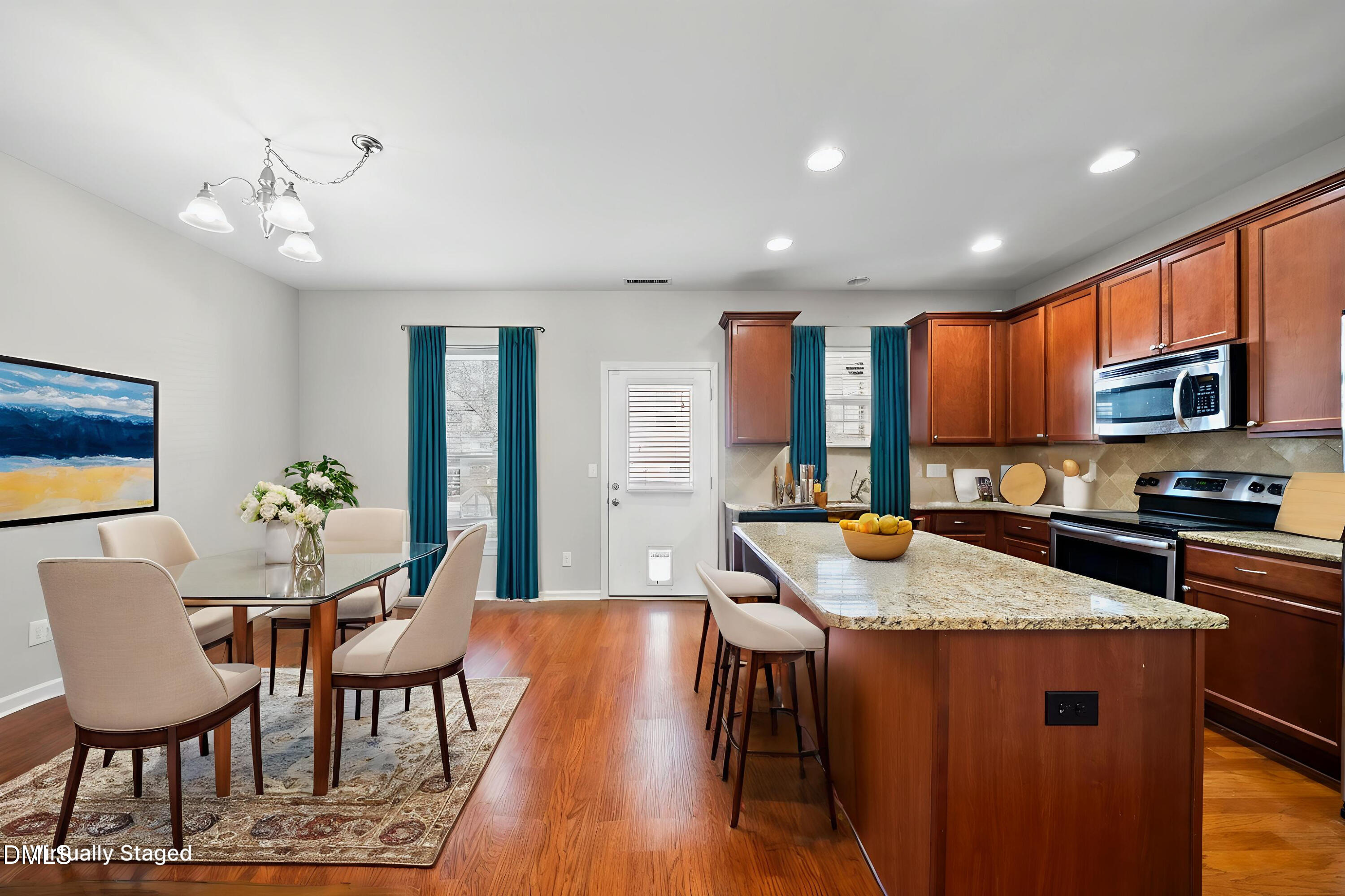 404 Provincial Street Raleigh, NC 27603 - Photo 5 of 24 a kitchen with stainless steel appliances granite countertop a kitchen island hardwood floor sink stove dining table and chairs