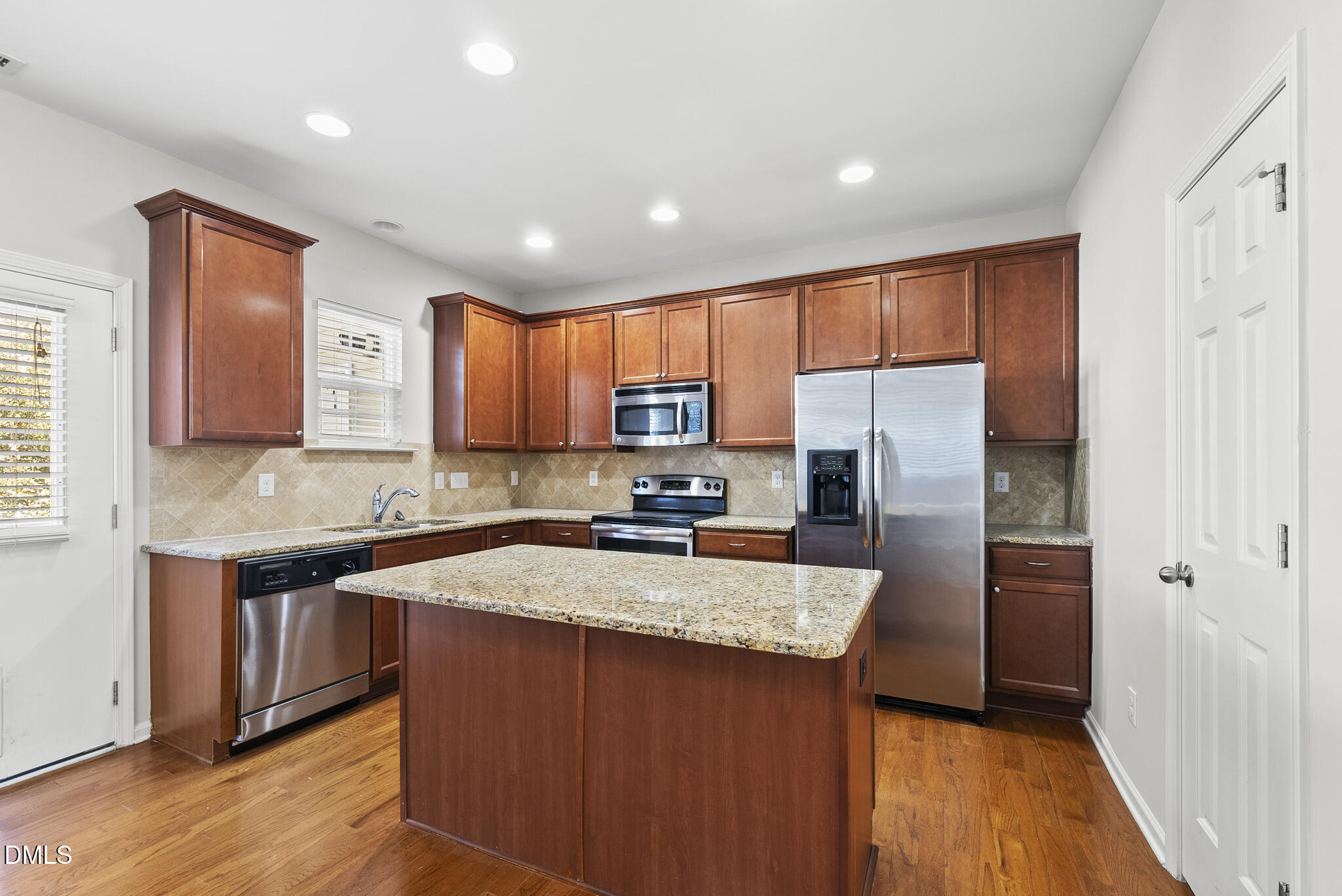 404 Provincial Street Raleigh, NC 27603 - Photo 6 of 24 a kitchen with stainless steel appliances granite countertop a sink stove refrigerator and cabinets
