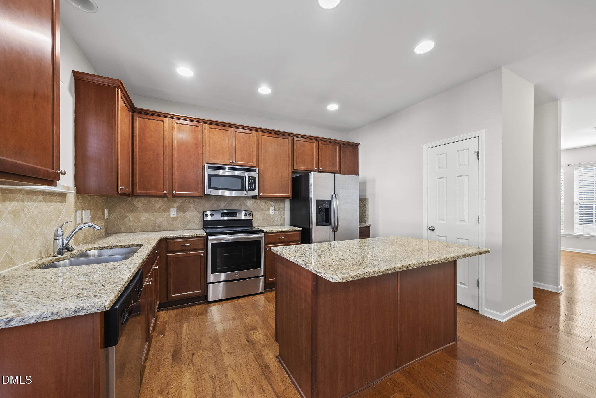 404 Provincial Street Raleigh, NC 27603 - Photo 7 of 24 a kitchen with stainless steel appliances granite countertop a sink stove refrigerator and microwave