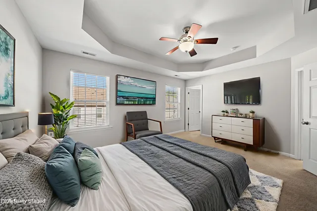 a bedroom with a large bed and a tv