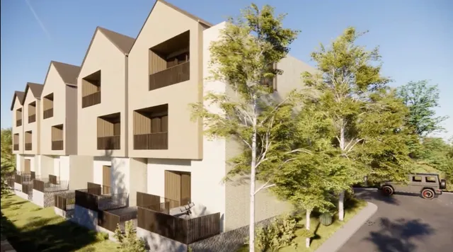 an aerial view of residential houses with city view