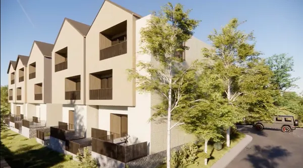 an aerial view of residential houses with city view