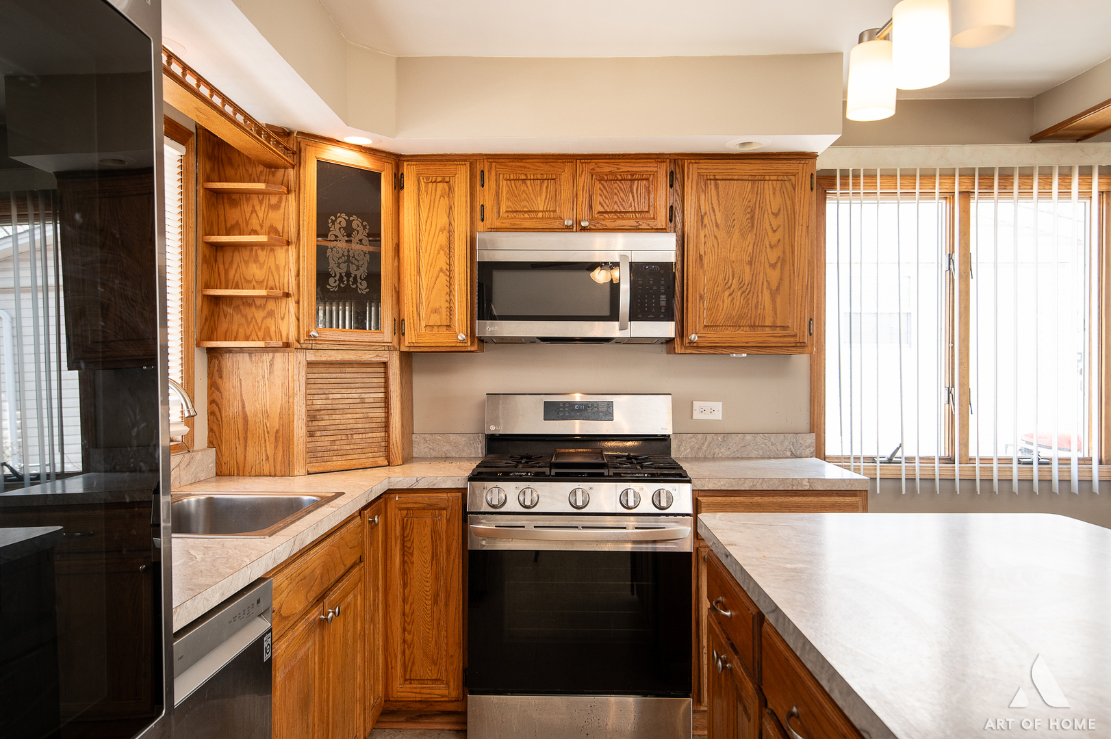 3034 190th Street Lansing, IL 60438 - Photo 6 of 25 a kitchen with a stove a sink and a microwave