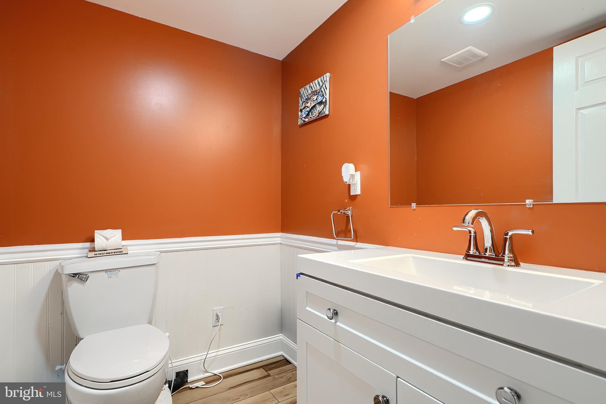 231 Gralan Road Catonsville, MD 21228 - Photo 24 of 37 a bathroom with a toilet a sink and mirror