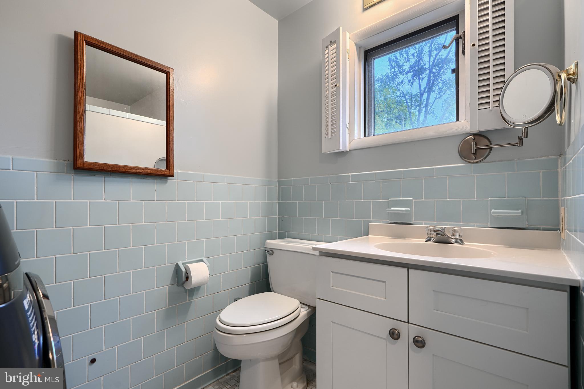 231 Gralan Road Catonsville, MD 21228 - Photo 32 of 37 a bathroom with a toilet sink and mirror