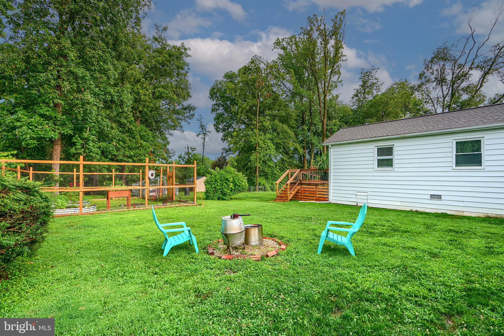 231 Gralan Road Catonsville, MD 21228 - Photo 33 of 37 a view of a backyard with table and chairs and wooden fence