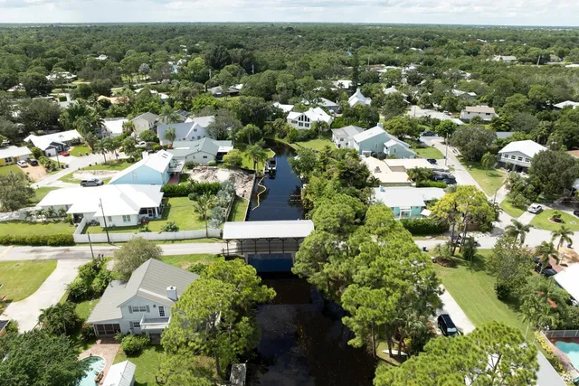 an aerial view of residential houses with outdoor space and river