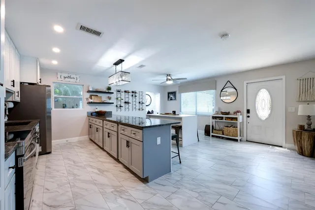 a kitchen with stainless steel appliances a stove top oven and a refrigerator