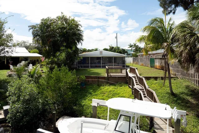 a view of a chair and tables in the backyard of the house
