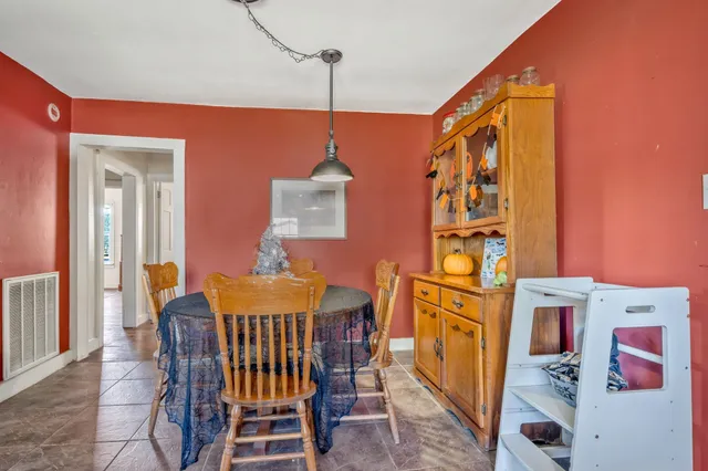 a dining room with furniture and wooden floor
