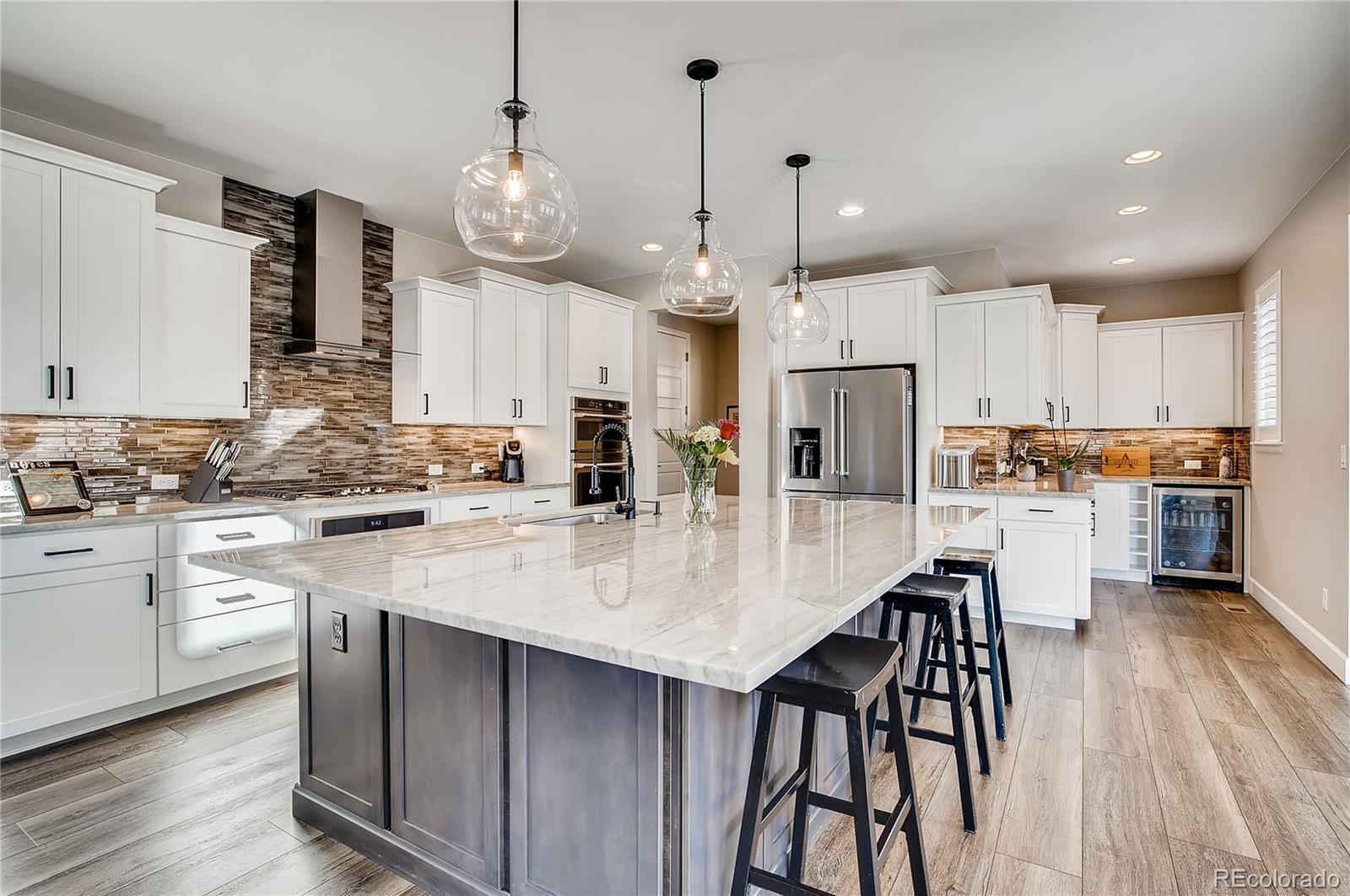 11330 Yellow Tip Point Parker, CO 80134 - Photo 11 of 50 a large kitchen with granite countertop lots of counter space dining table and stainless steel appliances