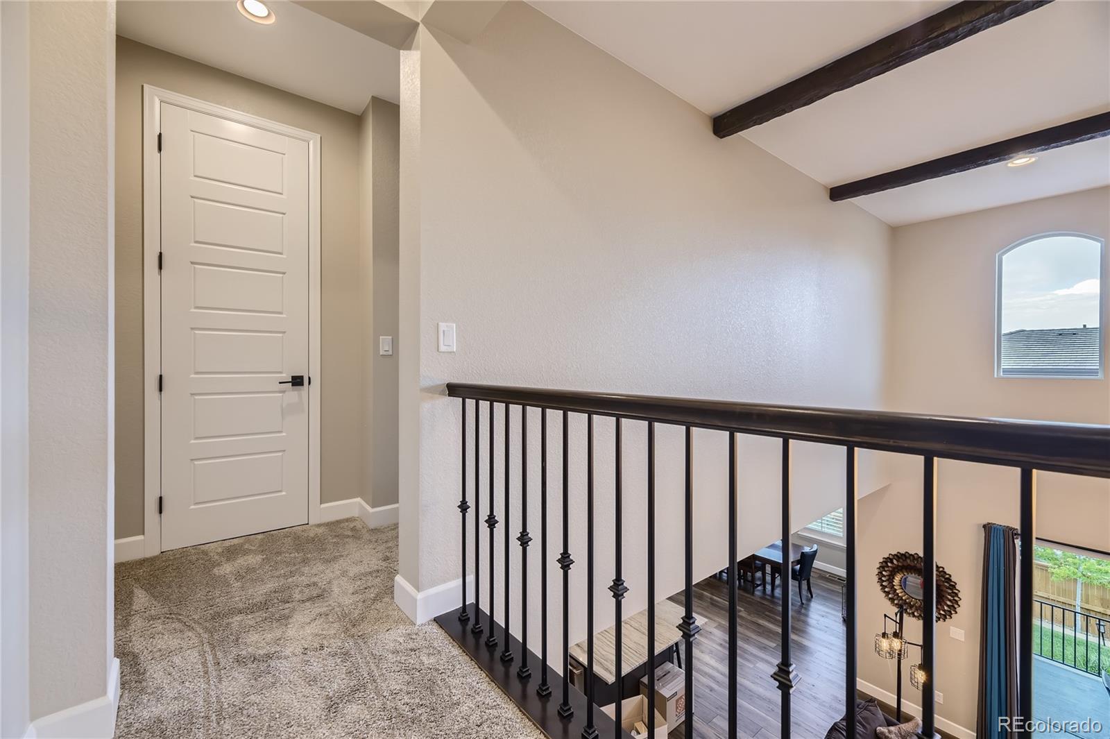 11330 Yellow Tip Point Parker, CO 80134 - Photo 21 of 50 a view of a hallway with wooden floor and staircase
