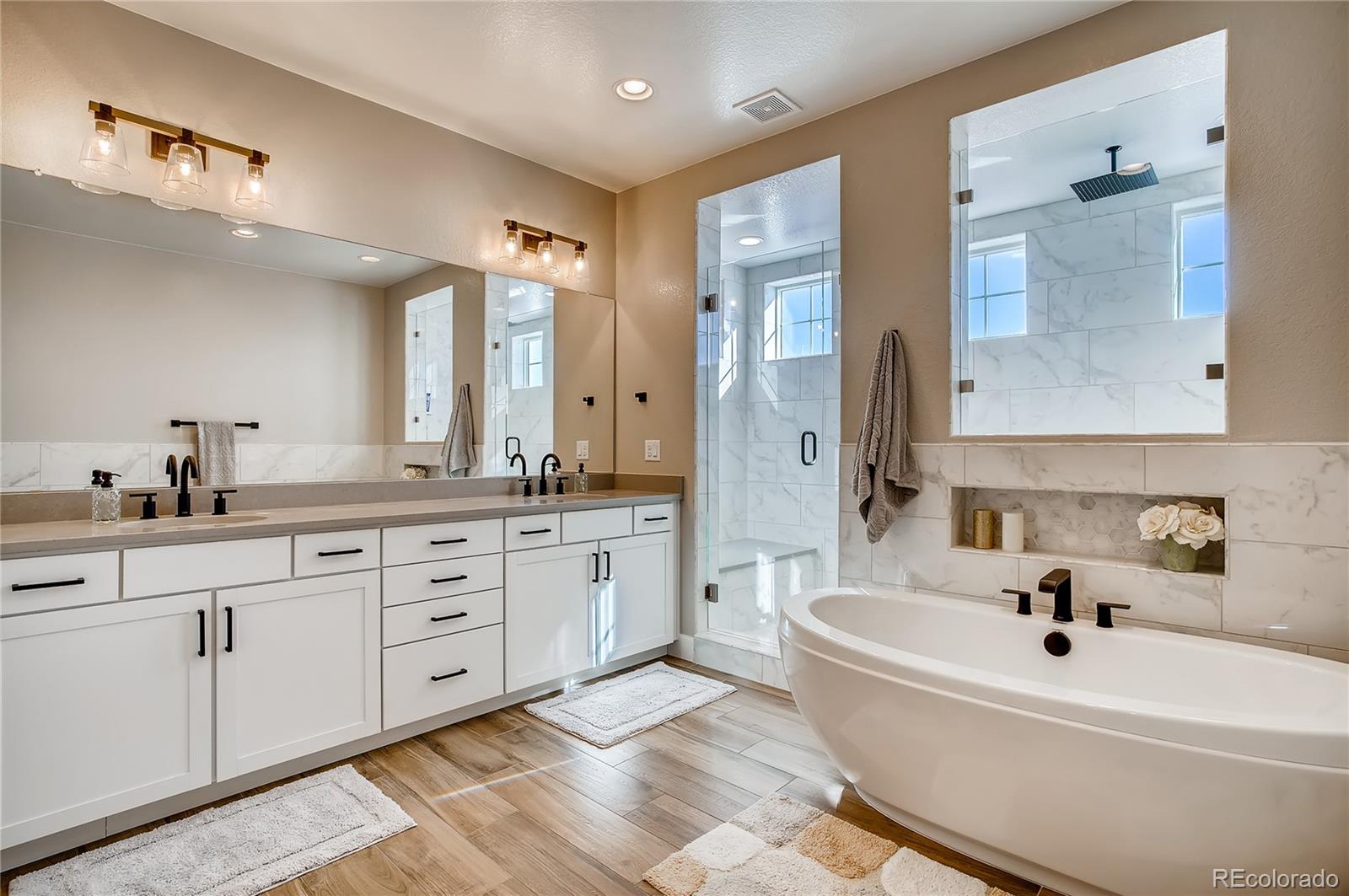 11330 Yellow Tip Point Parker, CO 80134 - Photo 25 of 50 a spacious bathroom with a double vanity sink mirror and bathtub