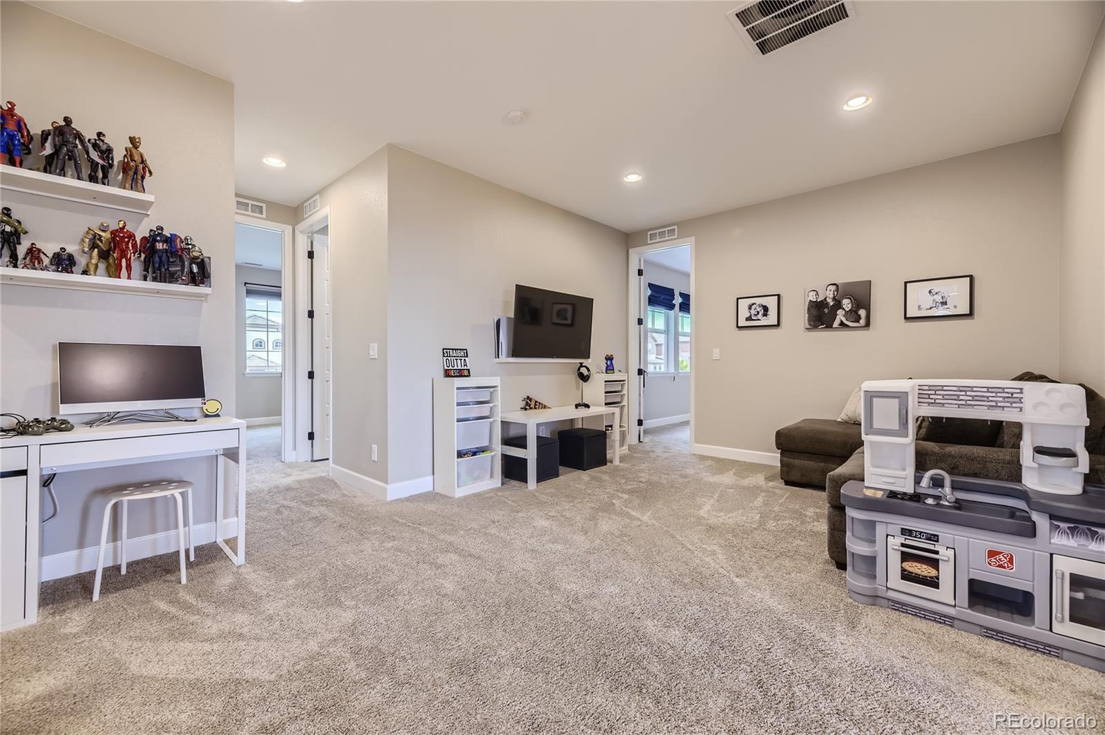 11330 Yellow Tip Point Parker, CO 80134 - Photo 29 of 50 a living room with furniture and a flat screen tv