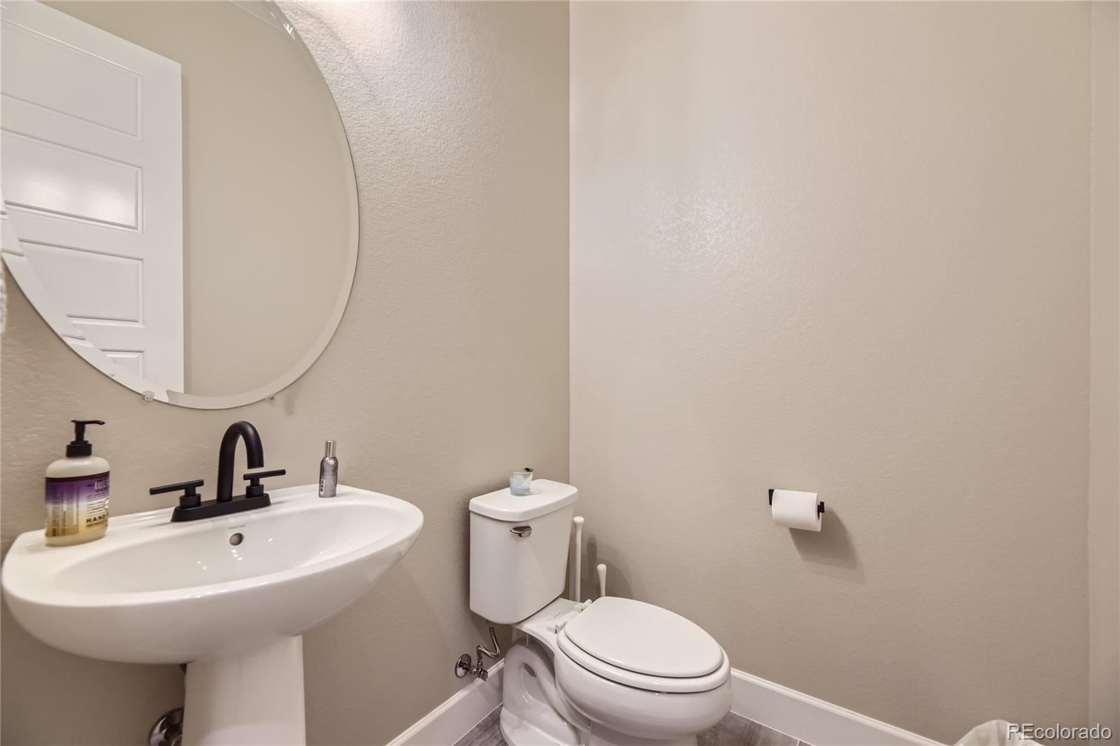 11330 Yellow Tip Point Parker, CO 80134 - Photo 42 of 50 a bathroom with a sink a mirror and toilet