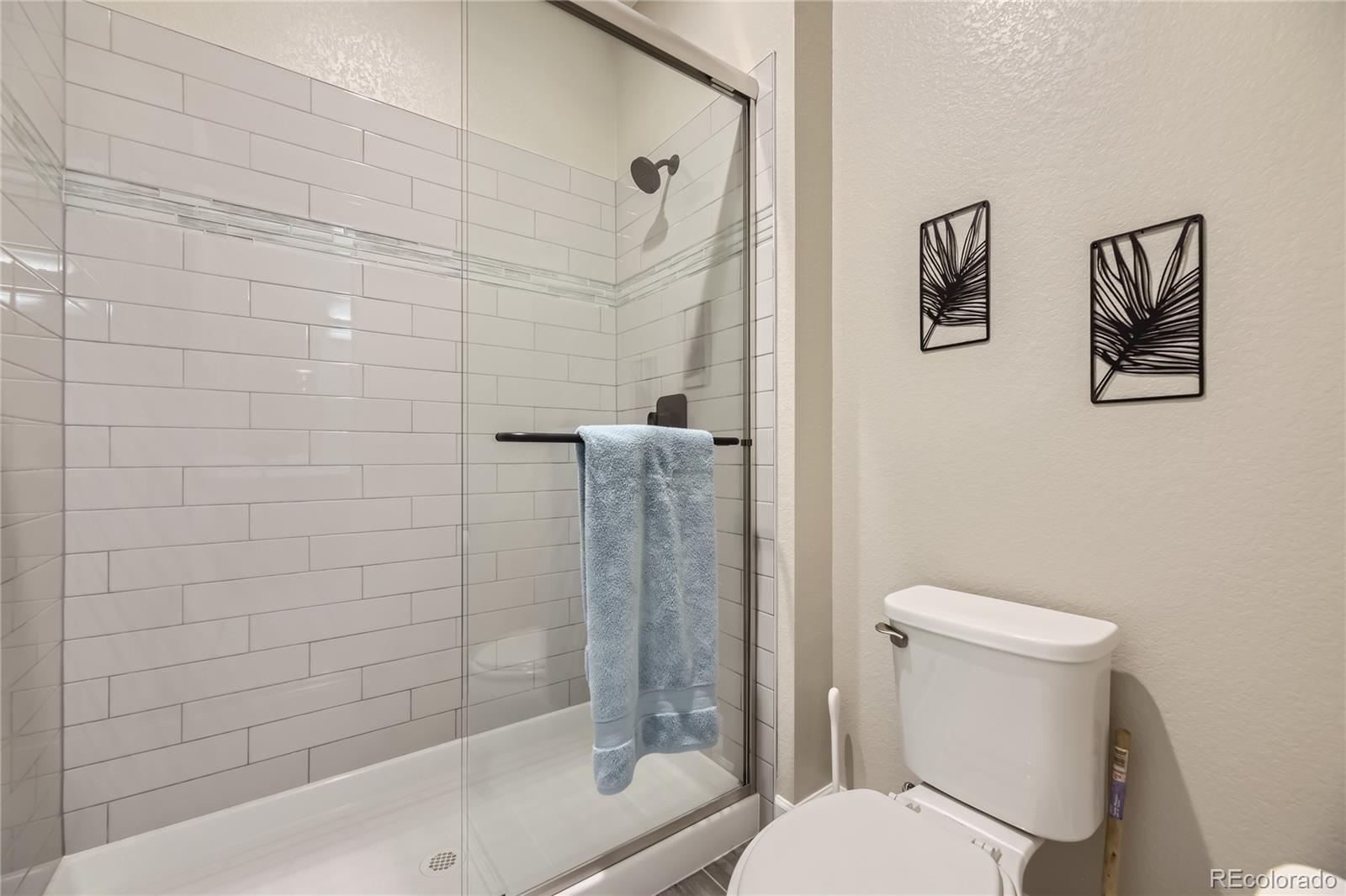 11330 Yellow Tip Point Parker, CO 80134 - Photo 45 of 50 a white toilet sitting next to a bath tub and a shower