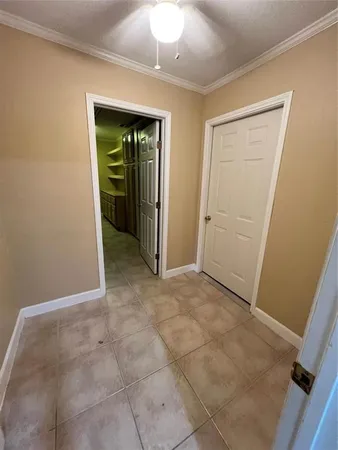 a kitchen with a refrigerator wooden floor and cabinets