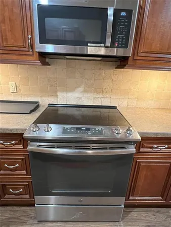 a stove top oven sitting inside of a kitchen