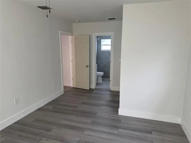 a bathroom with a toilet and a bath tub