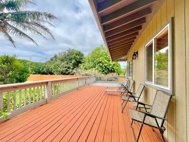 a view of balcony with wooden floor and seating space
