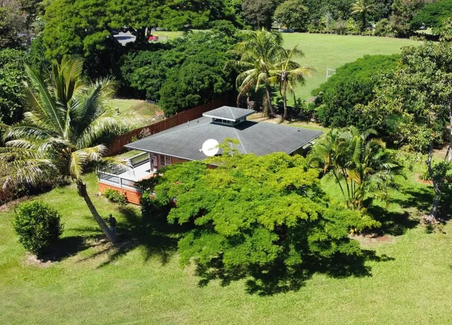 a backyard of a house with a yard and outdoor seating