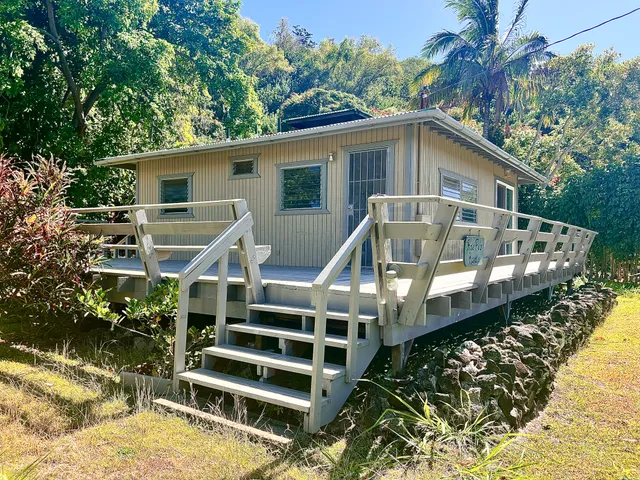 a view of a house with a balcony wooden deck and furniture