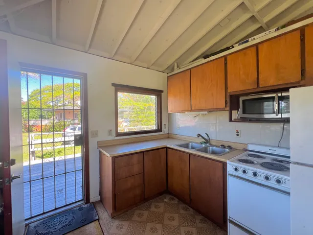 a kitchen that has a sink a window and appliances