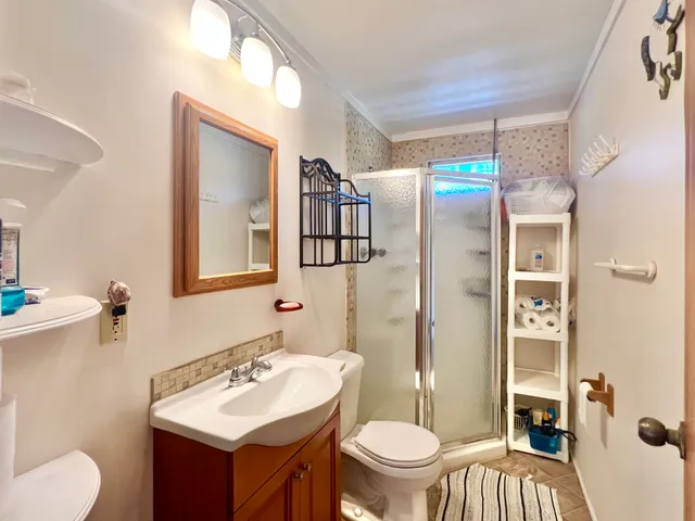 a bathroom with a sink toilet and shower