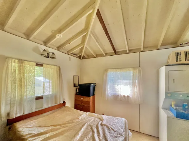 a bedroom with a bed next to a window