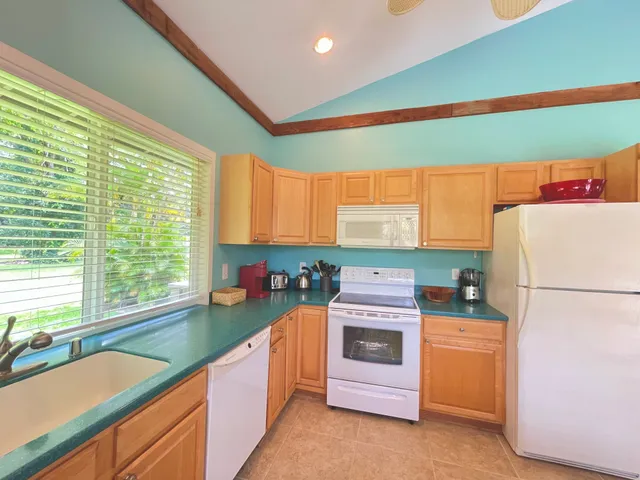 a kitchen with a refrigerator and a sink