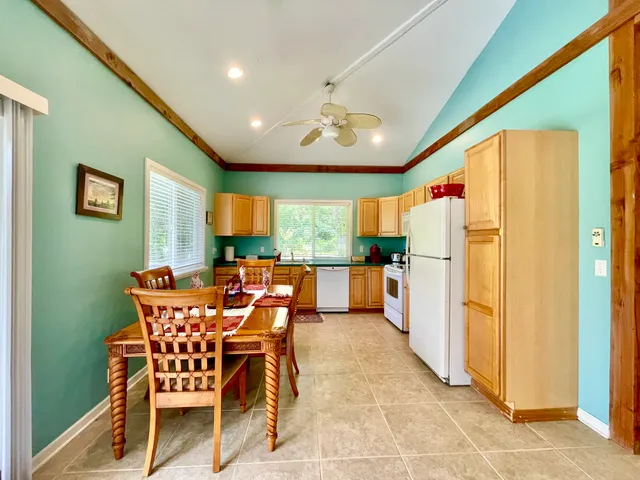 a dining room with furniture and a large window