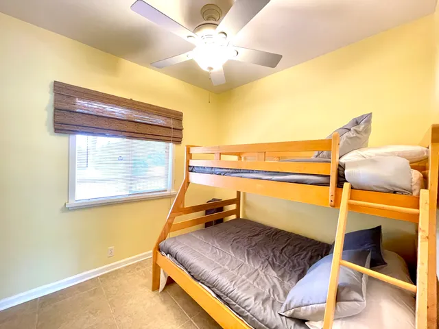 a bedroom with a bed and ceiling fan