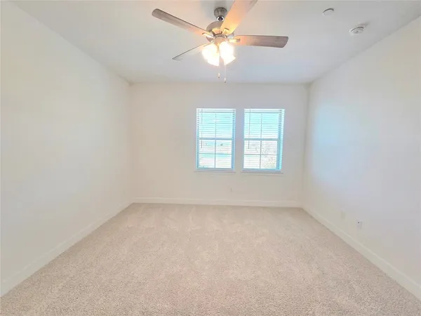 an empty room with windows and closet