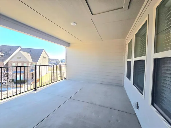 a view of a porch with wooden floor and a floor to ceiling window