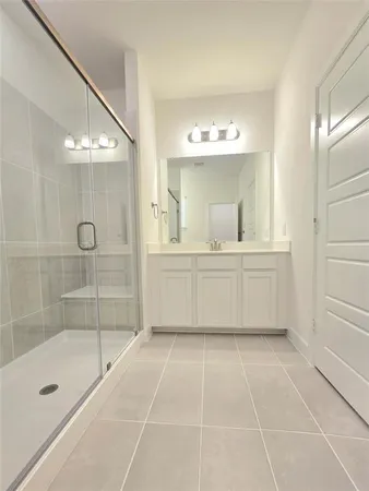 a bathroom with a shower a bathtub and a sink