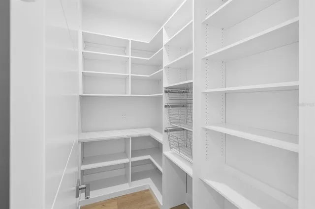 a view of walk in closet with empty racks