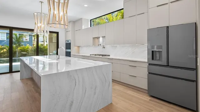 a kitchen with a sink stove and refrigerator