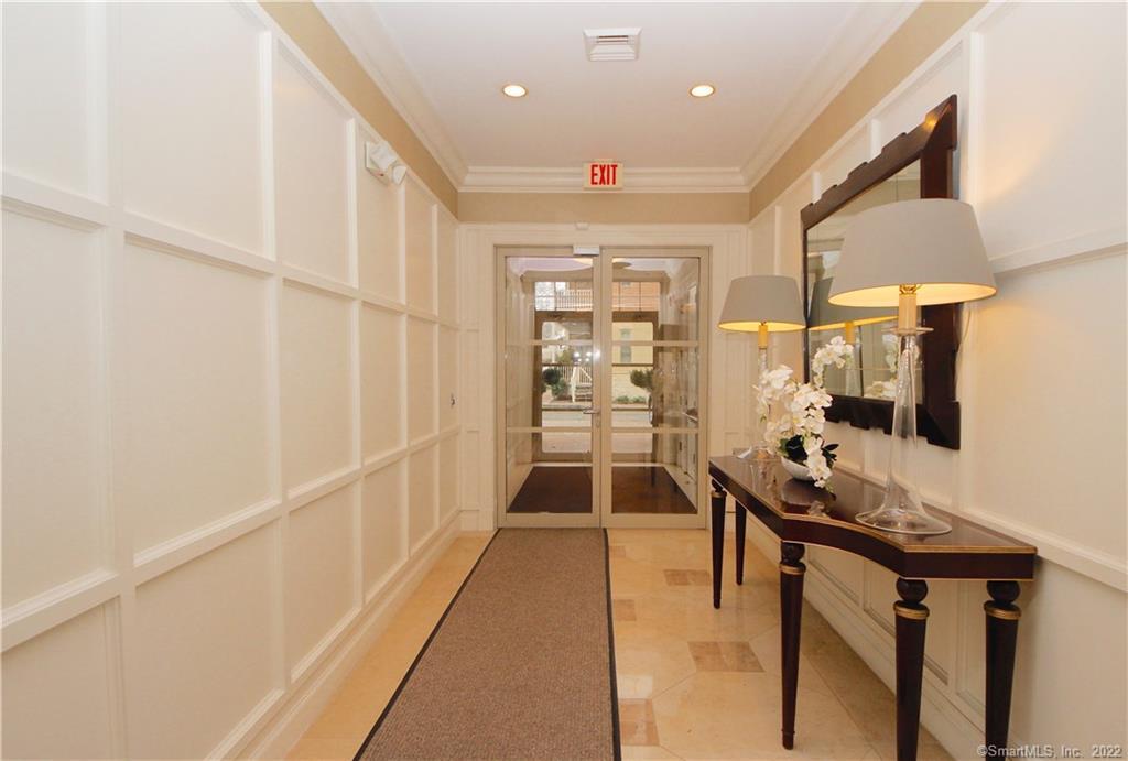 a hallway with furniture and wooden floor