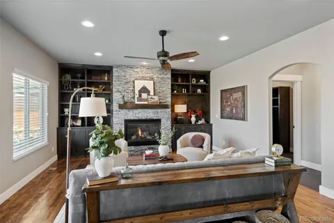 a living room with furniture and a fireplace