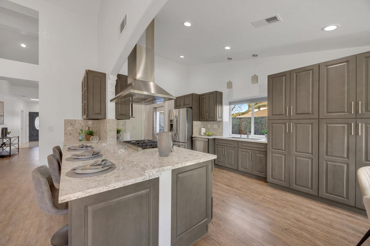1747 Nursery Way Pleasanton, CA 94588 - Photo 11 of 50 a kitchen with stainless steel appliances kitchen island granite countertop a sink refrigerator and cabinets