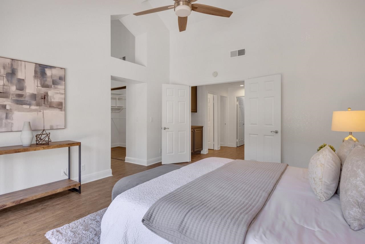 1747 Nursery Way Pleasanton, CA 94588 - Photo 35 of 50 a bedroom with a bed and a chandelier