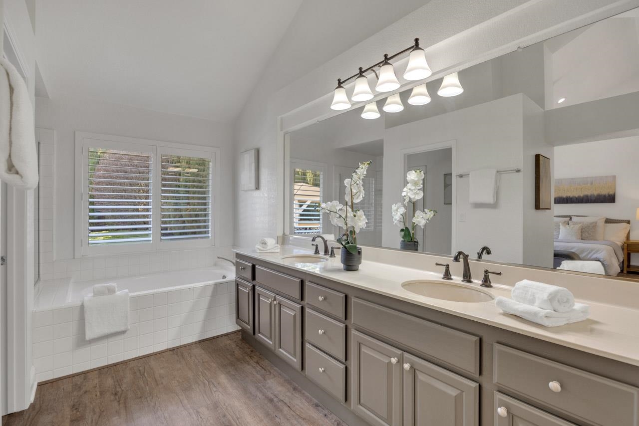 1747 Nursery Way Pleasanton, CA 94588 - Photo 37 of 50 a bathroom with a granite countertop sink a large mirror a bathtub and window