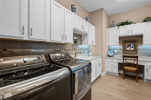 a kitchen with a stove and white cabinets