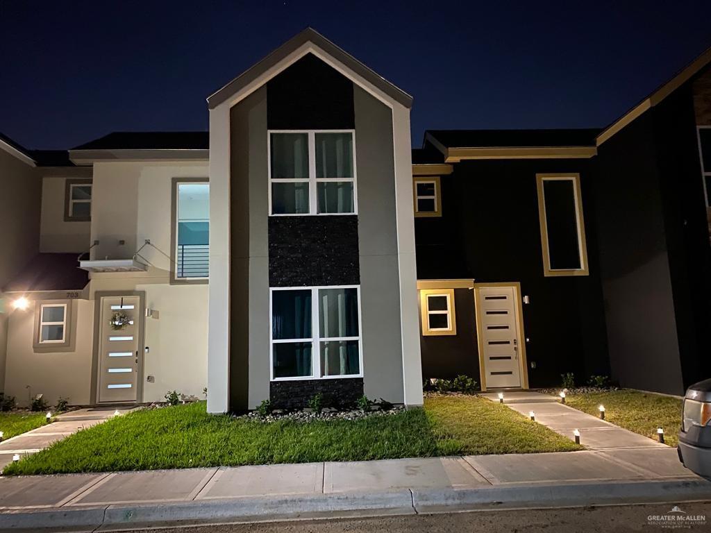 View of front of home featuring stucco siding and stone siding