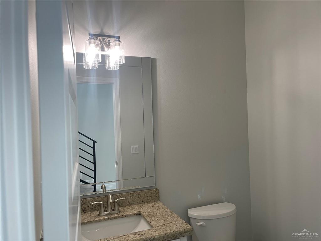 5515 North Crown Point Pharr, TX 78577 - Photo 3 of 15 Half bath featuring toilet and vanity